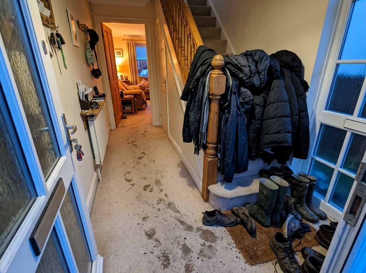 Getting Guest-Ready for the Festive Season 2 A hallway after guests arrive, with wet boots and grit on the carpet.